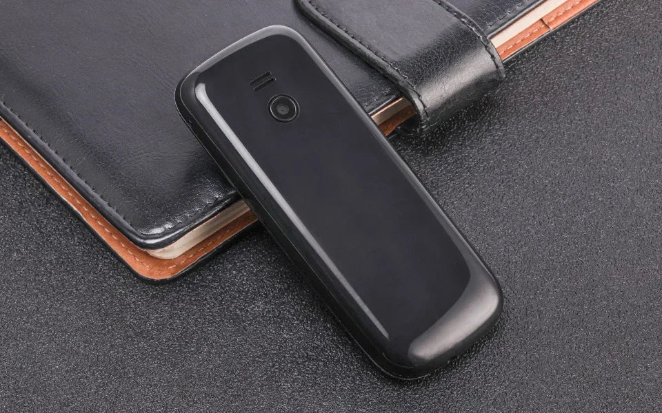 UNIWA E1803 2G precio bajo delgado GSM Mini teléfono móvil Dual SIM T9 teclado 800mAh batería Radio inalámbrica linterna teléfono para personas mayores